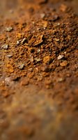Close-up of dry, crumbly soil texture with brown earth particles and small stones, suitable for agriculture, gardening, and environmental backgrounds.