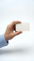 Male hand in blue shirt holding blank white business card on light background, mockup for branding and corporate identity design.