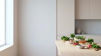 Modern minimalist kitchen interior with fresh vegetables and herbs on wooden countertop for healthy cooking and meal preparation in contemporary home.