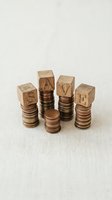Wooden alphabet blocks spelling SAVE stacked on coin towers representing financial planning and money saving strategies for future investment goals.