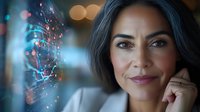 Mature Hispanic woman with confident smile and gray hair looking at glowing digital particles, representing technology and innovation in business leadership.