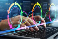 Software development lifecycle concept with colorful circular workflow diagrams over hands typing on laptop keyboard for agile project management.