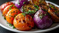 Grilled colorful vegetables on white plate with fresh herbs and seasonings, roasted tomatoes and purple onions with caramelized glaze and aromatic garnish.