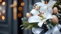 White lily bloom with golden eggs and greenery against blurred bokeh lights background, creating elegant Easter holiday composition with natural floral elements.