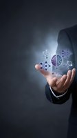 Businessman hand presenting glowing brain and network icons representing artificial intelligence and digital connectivity in modern technology concept.