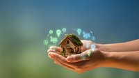 Smart home technology concept with hands protecting miniature house surrounded by digital icons representing automation, security, and energy efficiency systems.