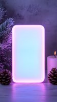 Glowing neon rectangle frame with pine branches, burning candle and pine cones in purple atmospheric lighting on wooden surface, winter holiday mockup background.