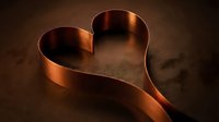 Elegant copper ribbon forming heart shape on dark textured surface with warm lighting for romantic designs and luxury branding concepts.