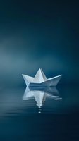 White paper boat floating on calm blue water with reflection creating peaceful minimalist scene for meditation and tranquility concepts.