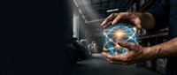 Male hands holding glowing digital globe with network connections in industrial warehouse setting for technology and global business concepts.