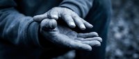 Homeless person's cupped hands reaching out for help, symbolizing poverty, charity, and social assistance needs in urban environment.