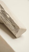 Natural pumice stone for skincare and exfoliation on neutral beige background with soft shadows and minimalist aesthetic for spa and wellness concepts.