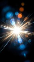 Bright starburst light explosion with colorful bokeh circles and lens flare effects on dark background for creative projects and digital art.