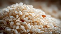Close-up of raw white rice grains with selective focus showing texture and natural color variations, suitable for food industry and culinary content.