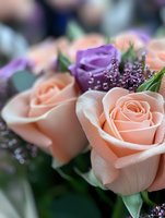 Fresh peach and purple roses in romantic bouquet with delicate water droplets and soft focus background, featuring elegant floral arrangement for wedding or celebration.