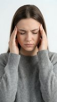 Young Caucasian woman experiencing severe headache holding temples with closed eyes wearing gray sweater on white background for health concepts.