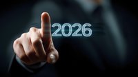 Business professional pointing at glowing digital 2026 number floating in dark space, representing future planning and digital transformation concept.