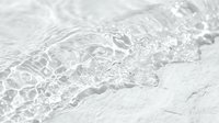 Clear water wave with bubbles and ripples on a white surface, showcasing purity and freshness for cosmetic or spa backgrounds.