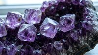 Amethyst crystal cluster with raw purple quartz formations on dark matrix, isolated mineral specimen for geology, jewelry design, and educational content.