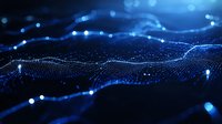 Glowing blue particles form dynamic waves against dark background, creating futuristic network visualization with bokeh light effects and depth of field.