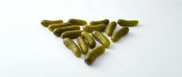 Pickled gherkins arranged in triangle shape on white background, isolated for food packaging, culinary design, and restaurant menu applications.