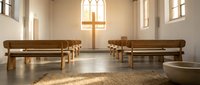 Serene modern chapel interior with wooden benches, natural light from arched windows, and minimalist cross symbol for worship spaces and spiritual design projects.