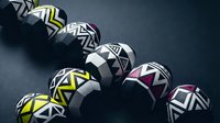 Modern geometric spheres with bold black and white patterns and colorful accents arranged on dark surface for contemporary design projects.