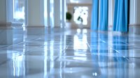 Empty hospital corridor with shiny reflective floor, blue curtains, and natural light streaming through windows, creating a clean and sterile medical environment.
