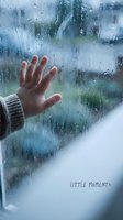 Hand pressed against rain-covered window glass with water droplets creating melancholy atmosphere for emotional storytelling and mental health concepts.