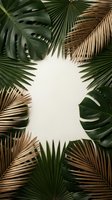 Tropical palm leaves and monstera frame with copy space on neutral background for summer vacation design and natural botanical decoration.