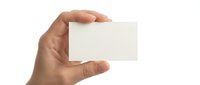 Hand holding blank white business card mockup on transparent background for branding and corporate identity design projects.