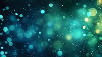 Magical turquoise and yellow bokeh lights on dark background with glowing particles and sparkles create dreamy atmospheric effect for festive designs.