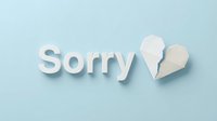 Sorry text with broken paper heart on light blue background, symbolizing apology, regret, and relationship healing concept.