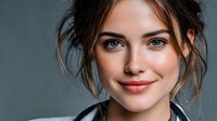 Professional young Caucasian businesswoman with messy bun hairstyle and natural makeup smiling confidently at camera for corporate headshot photography.