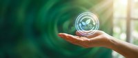 Hand holding a glowing CO2 reduction hologram with green leaves, symbolizing carbon footprint awareness, sustainability, and eco-friendly environmental commitment.