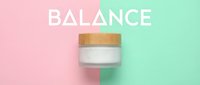 Cosmetic jar with wooden lid on split pink and mint background symbolizing balance and skincare harmony for beauty product marketing.