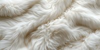 Luxurious white faux fur texture with soft waves and ripples creating an elegant plush surface pattern, suitable for fashion and interior design backgrounds.
