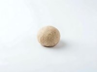 Whole wheat dough ball isolated on white background, ready for baking, cooking, or bakery design projects.