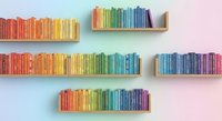 Colorful books arranged by rainbow spectrum on floating wooden shelves against pastel gradient wall creating organized library display for home decor and reading space.