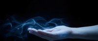 Open palm hand with flowing blue smoke or energy waves against dark background for mystical and spiritual design concepts.