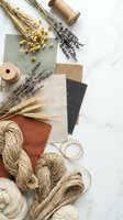 Natural textile samples with dried lavender and wheat creating earthy color palette for interior design and craft projects on marble surface.