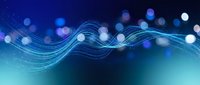 Abstract blue flowing waves with glowing bokeh lights creating dynamic energy pattern for modern digital backgrounds and technology presentations.