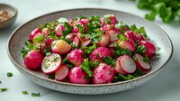 Fresh radish salad with herbs and seasonings served in rustic ceramic bowl, healthy vegetarian dish perfect for spring dining and clean eating lifestyle.