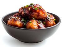 Glazed chicken wings in dark bowl with teriyaki sauce and green onions garnish on white background, appetizing Asian cuisine dish for restaurant menu or food delivery.