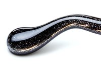 Flowing black glass wave with golden glitter sparkles on white background, abstract macro photography for luxury design and modern art decoration.