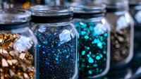 Glass jars filled with sparkling blue and turquoise glitter, sequins, and metallic decorative elements create magical crafting supplies display for DIY projects and celebrations.