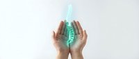 Protective hands surrounding glowing green spine hologram representing healthcare, chiropractic care, and medical spine treatment concepts.
