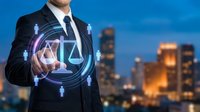 Professional businessman touching digital justice scale interface with legal icons against urban cityscape background at dusk for corporate law services.