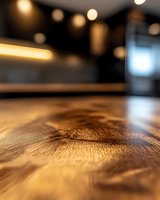 Macro shot of wooden table surface with natural grain texture and bokeh lights in background, shallow depth of field creates atmospheric restaurant ambiance.