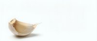 Single garlic clove isolated on white background, ready for culinary, food, and cooking design projects.